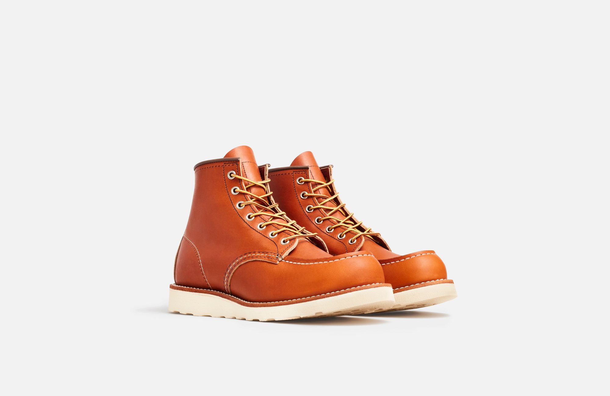 Front Angle of A Red Wing men's moc toe boot made of brown premium leather, featuring a Goodyear welt construction and a Traction Tred rubber outsole.