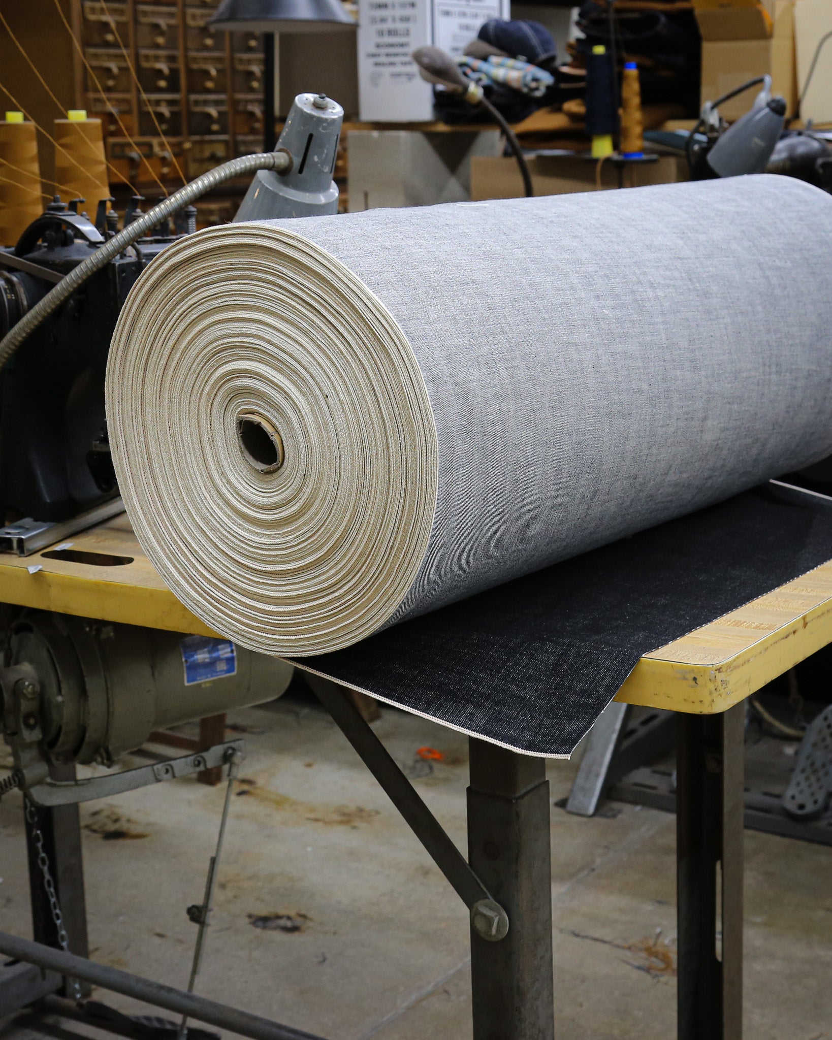 Roll of X129 fabric on a table in a workshop setting