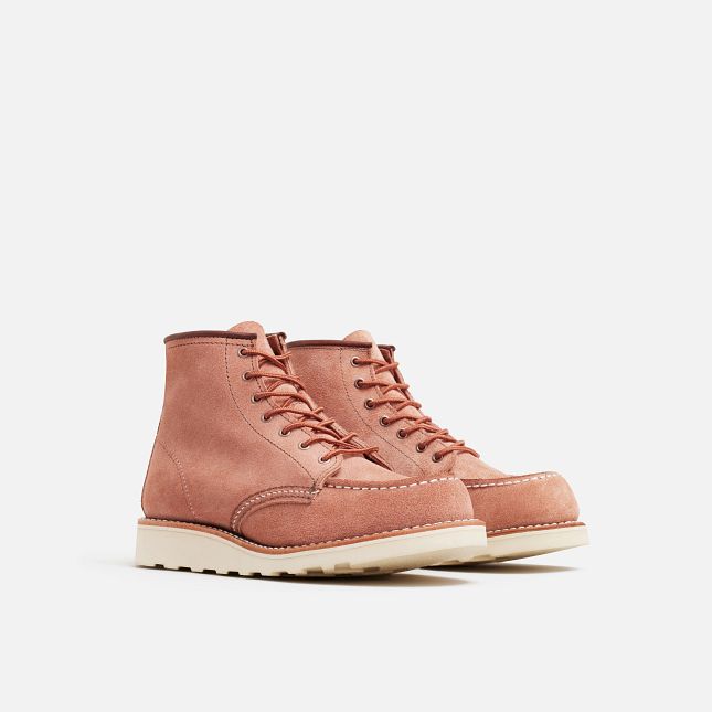 Front Angle of A pair of Red Wing women's boots in dusty rose color with lace-up closure and a moc toe style.
