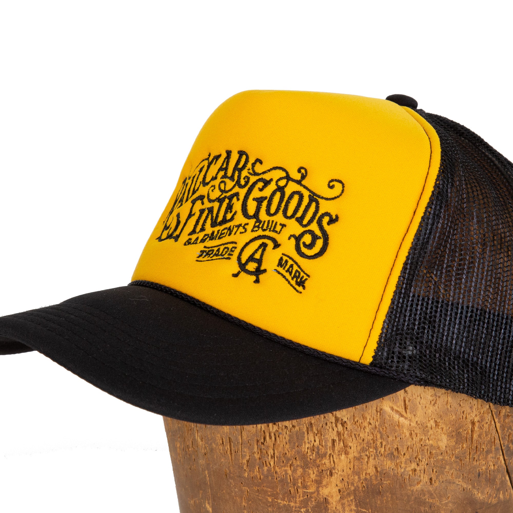 Close Up Front Angle of Railcar Typography Trucker Embroidered Yellow Black Hat