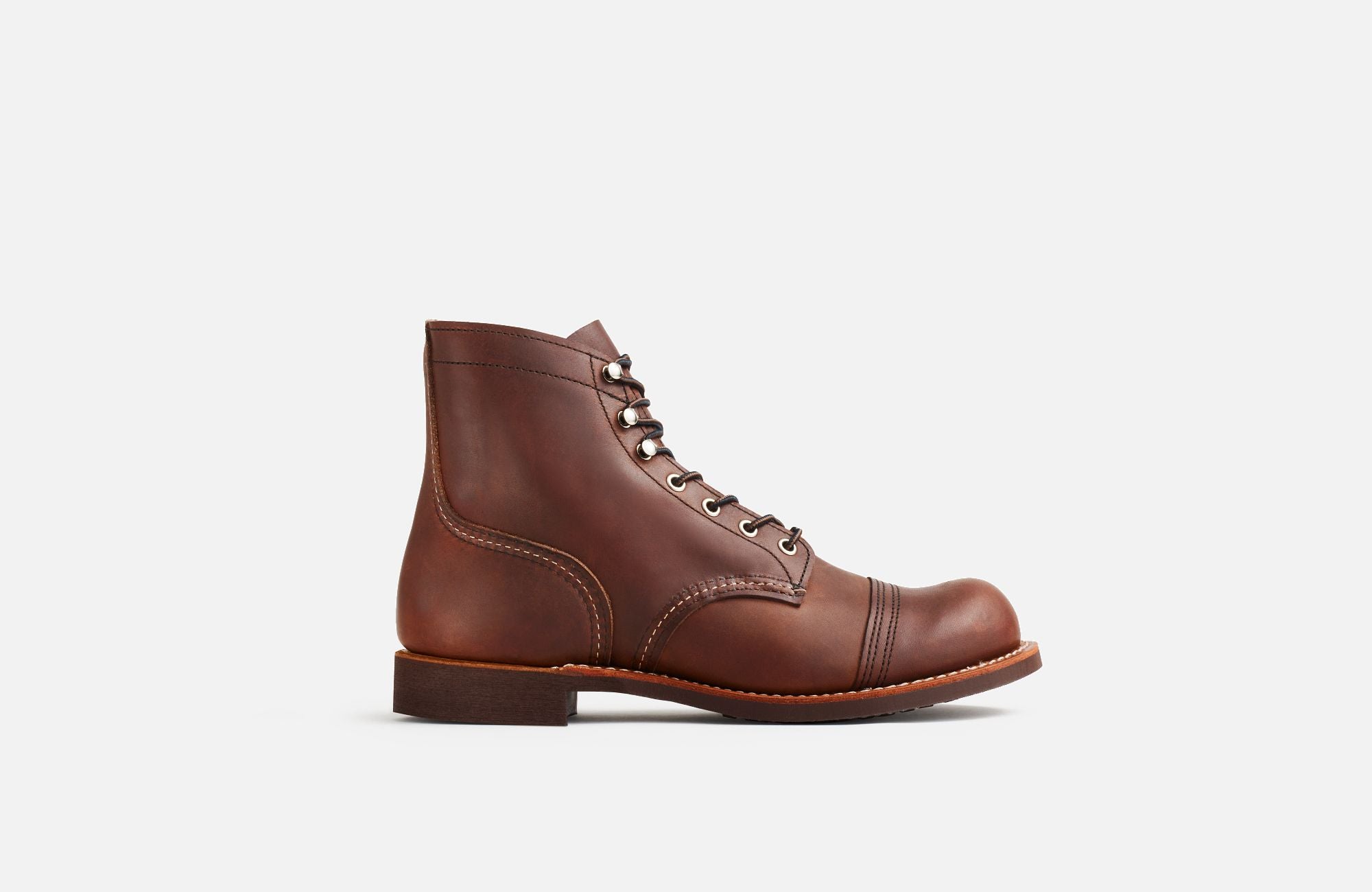 Side View of A Red Wing Men's Iron Ranger Amber Harness boot, featuring a brown leather upper, chrome hardware, and a Vibram sole.