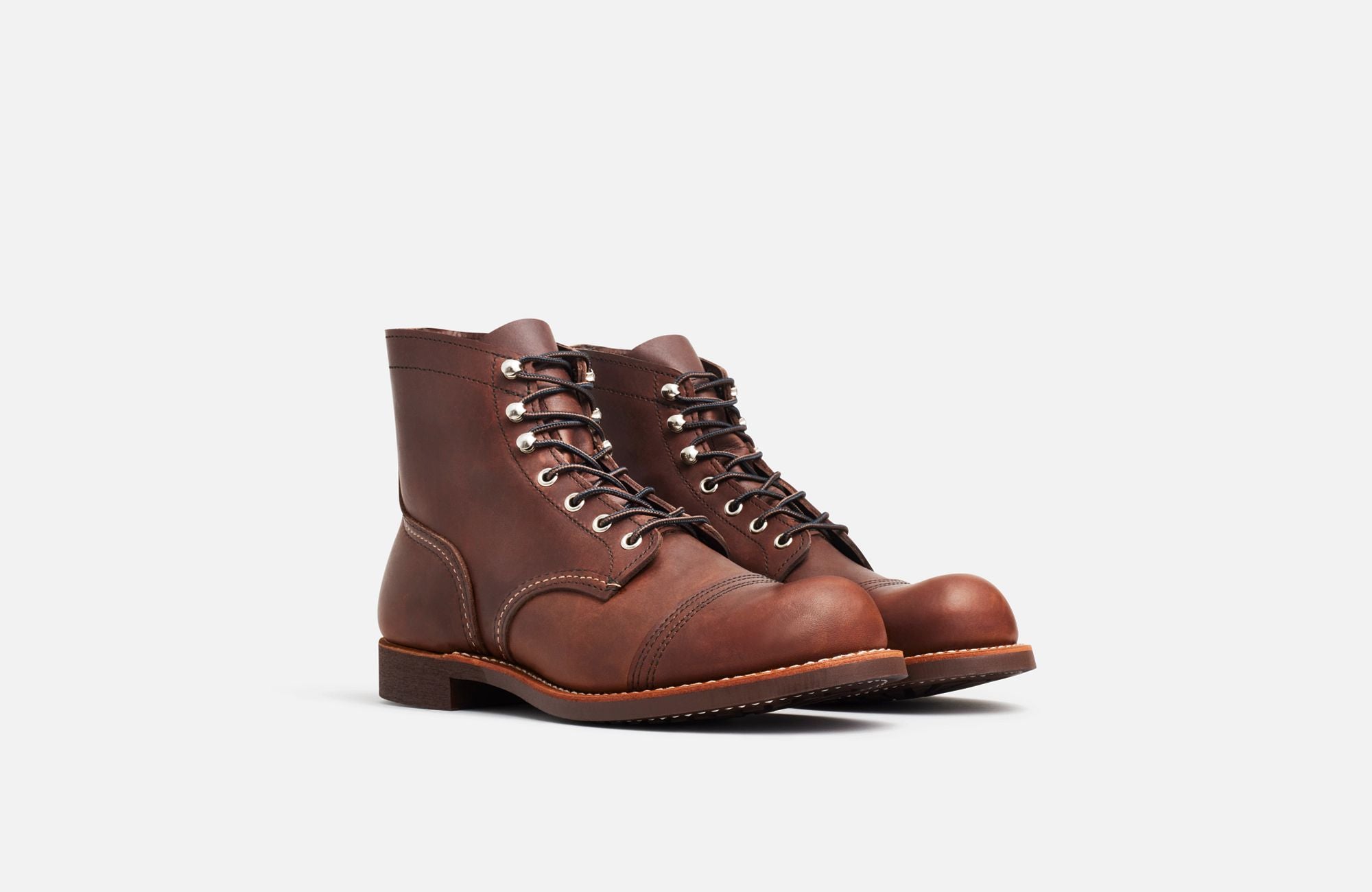 Front Angle of A Red Wing Men's Iron Ranger Amber Harness boot, featuring a brown leather upper, chrome hardware, and a Vibram sole.