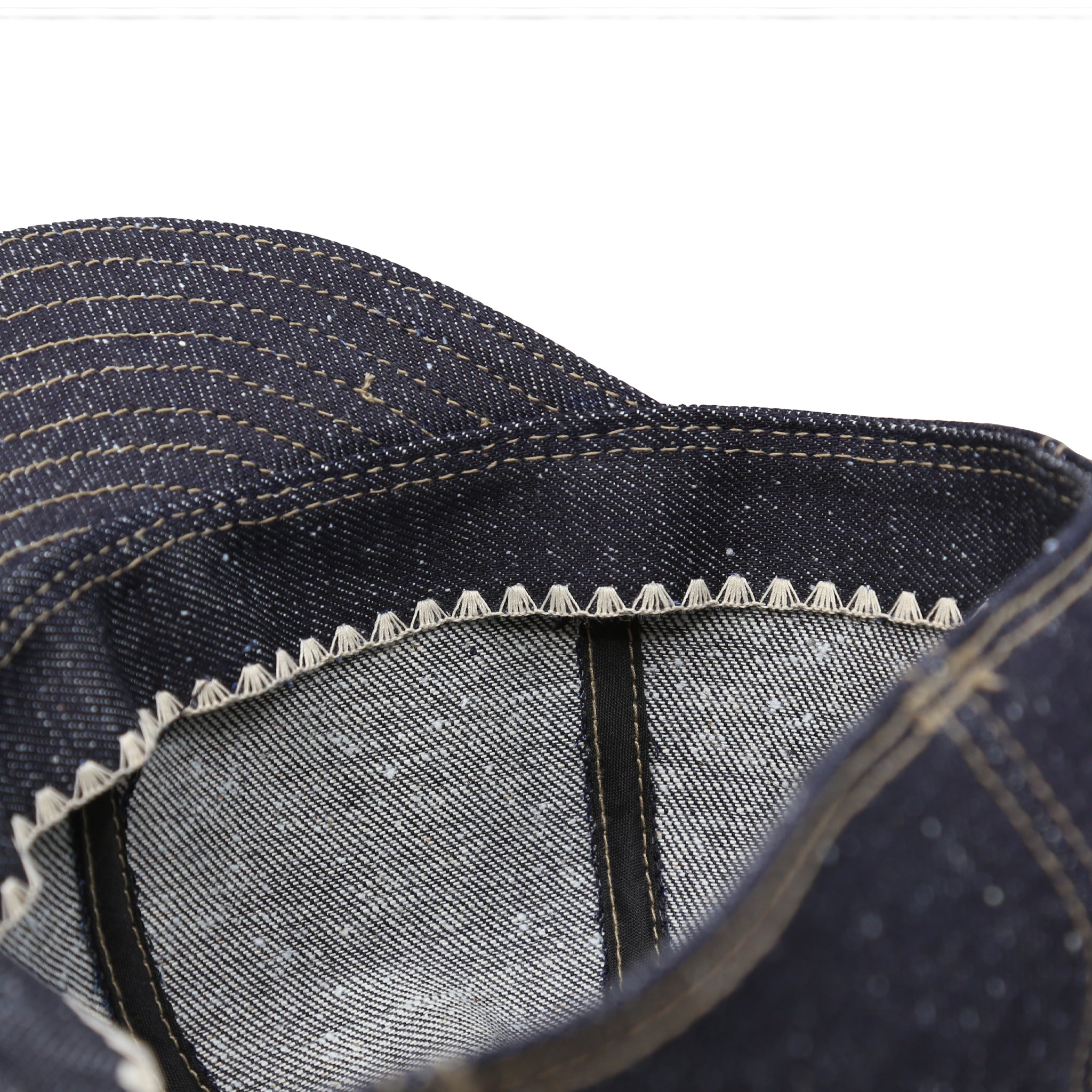 Interior Detail of a A dark blue nep denim mechanic hat with visible stitching.