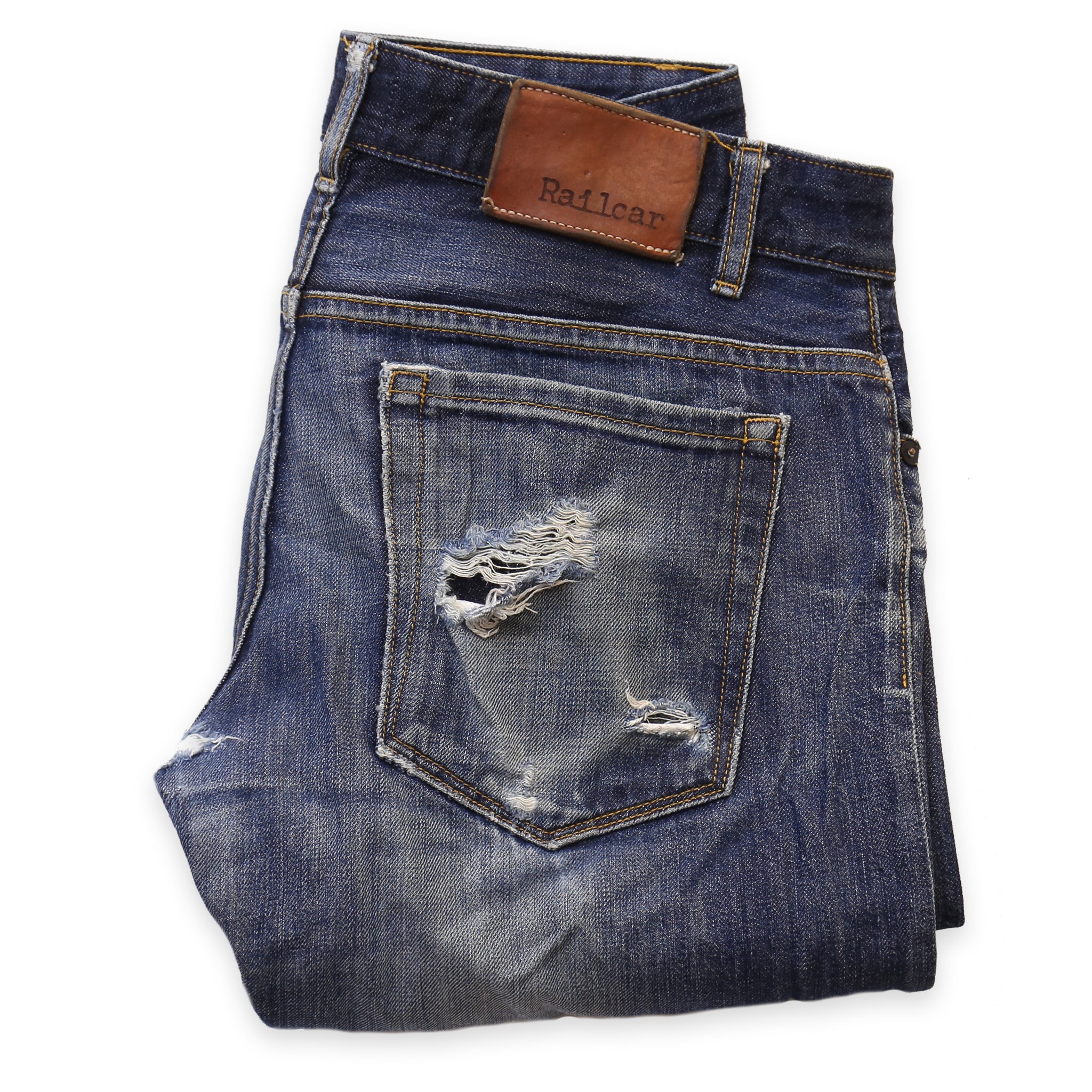 A pair of denim jeans with the back pocket needing repair
