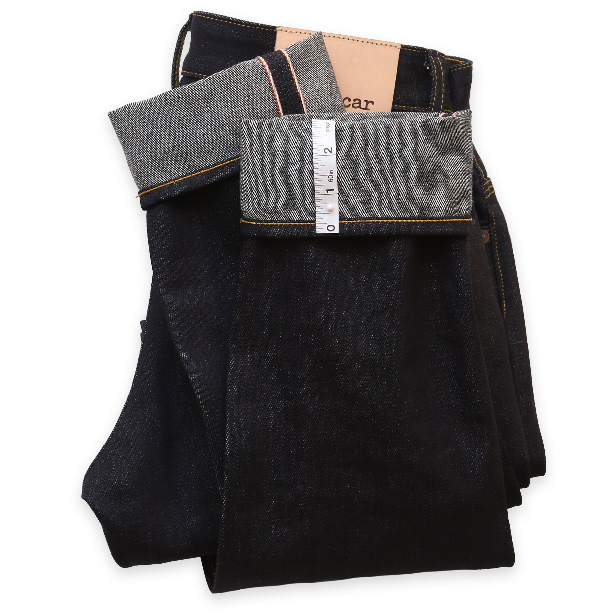 A pair of jeans laid out flat showing the hem area, with the brand name 'Railcar' visible on the tag.