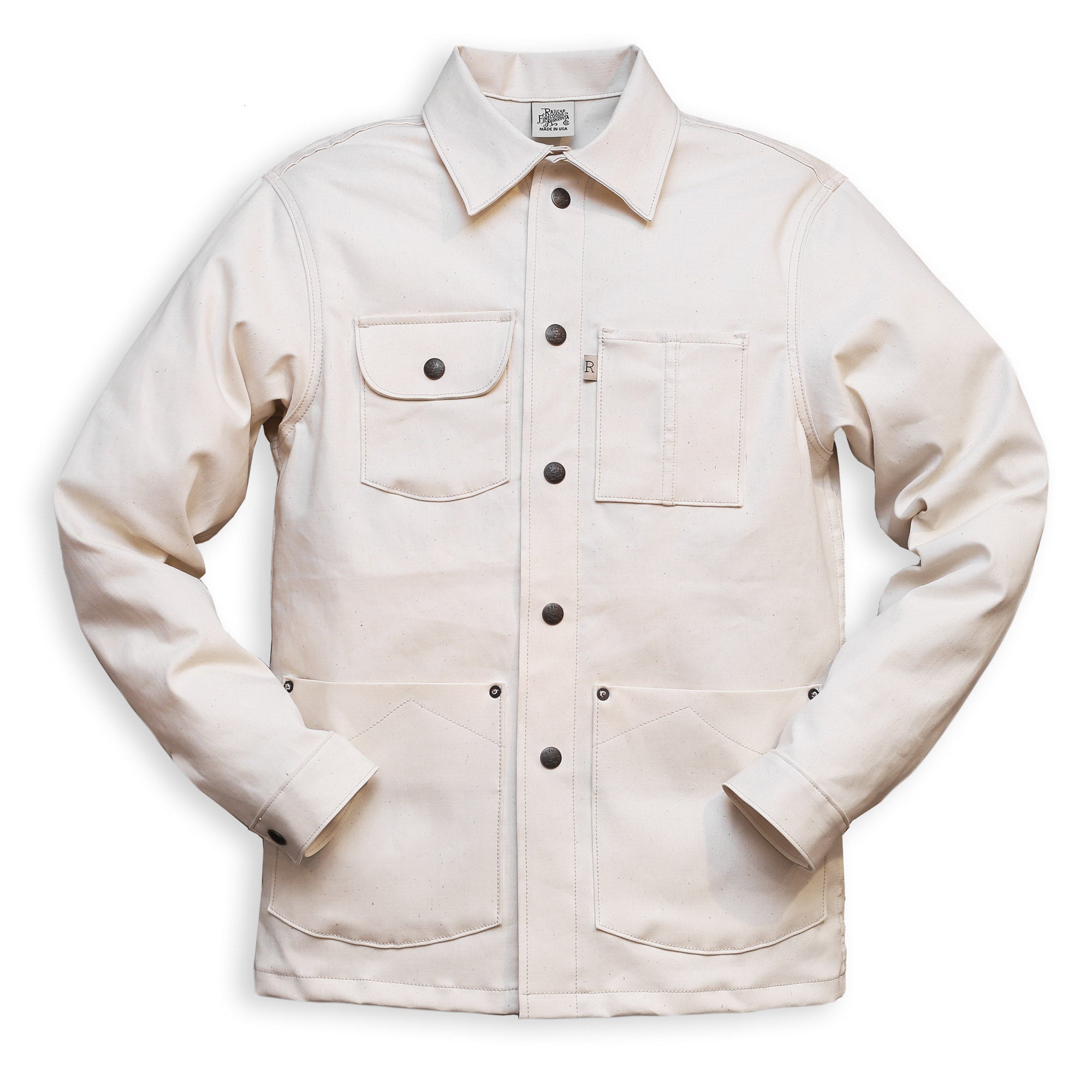A natural seed chore coat with snap buttons, featuring a collar, front pockets, and long sleeves.