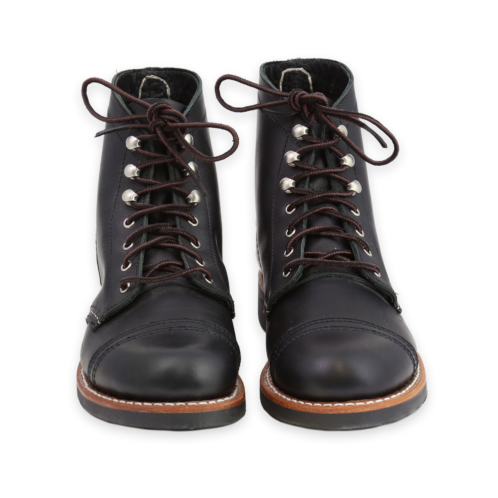 Front of A pair of women's black iron ranger boots with lace-up closure and a Vibram sole.