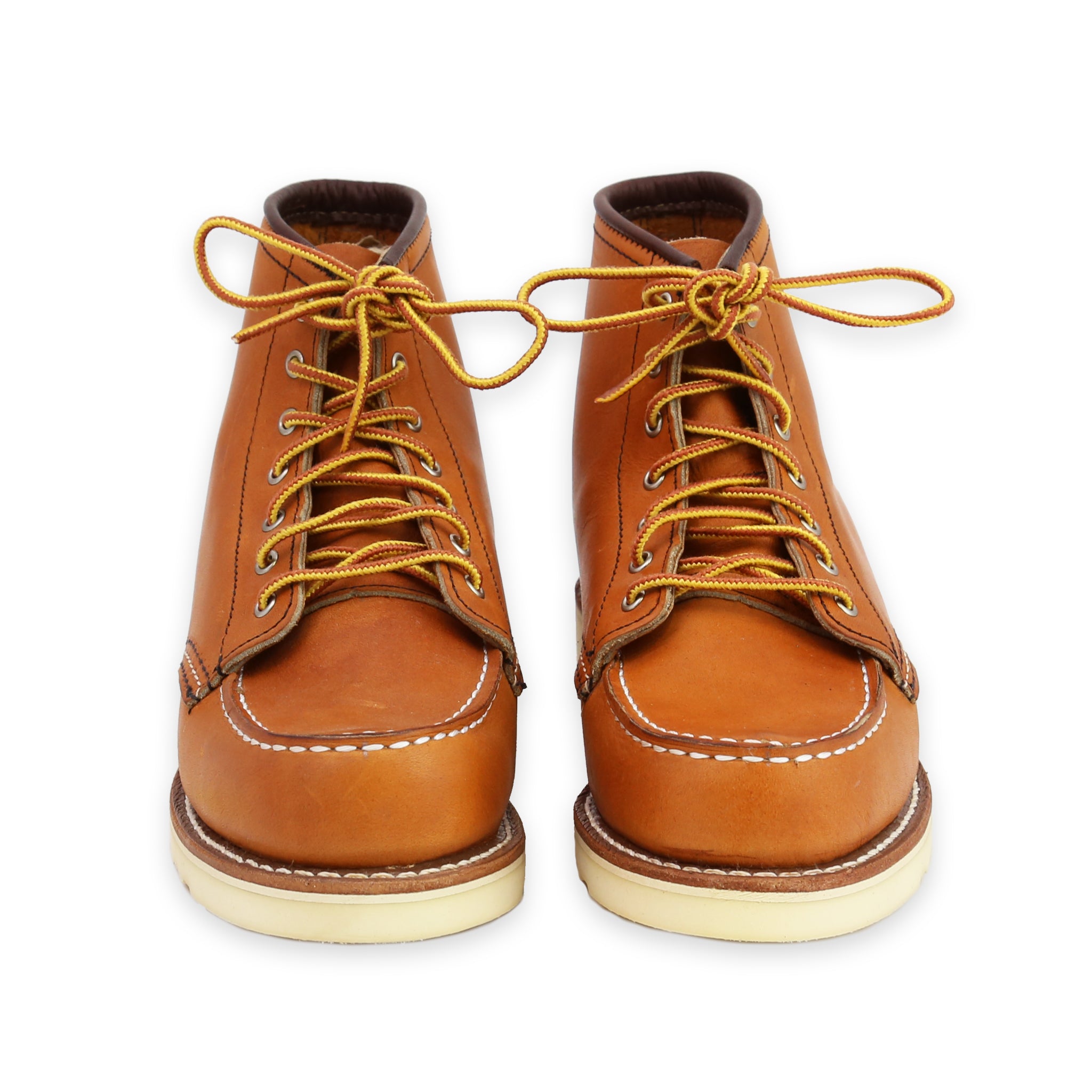 Front View of A pair of women's Red Wing Classic Moc Toe Oro Legacy boots with brown leather uppers and a white outsole, featuring lace-up closure.
