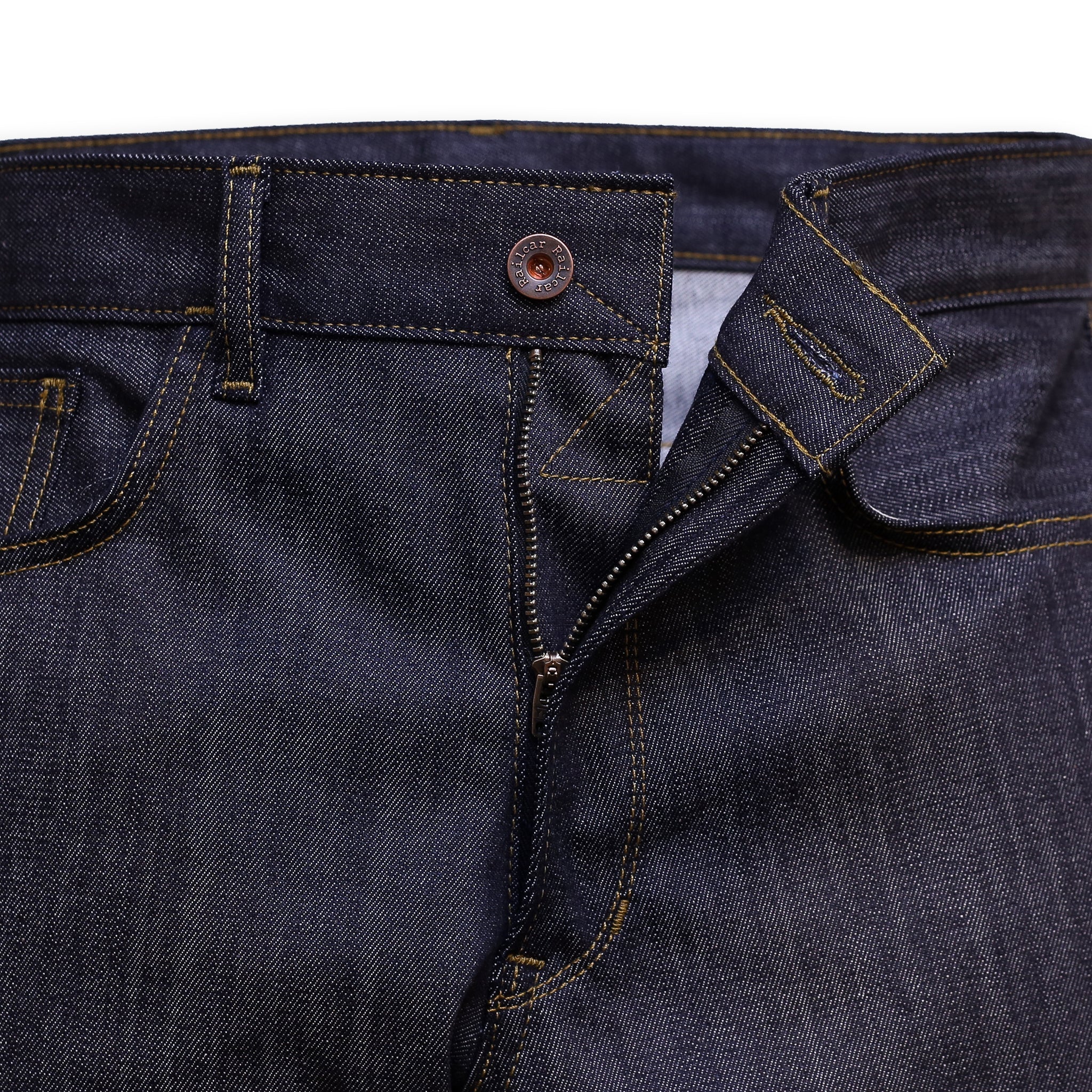 Zipper detail of a pair of slim-fit blue denim jeans with a minimalist design