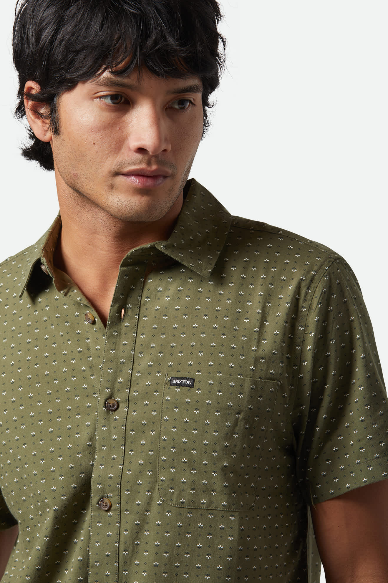 Model Photo Close Up of Brixton Men's Charter Print Short Sleeve Woven - Ivy Green Micro Floral 
