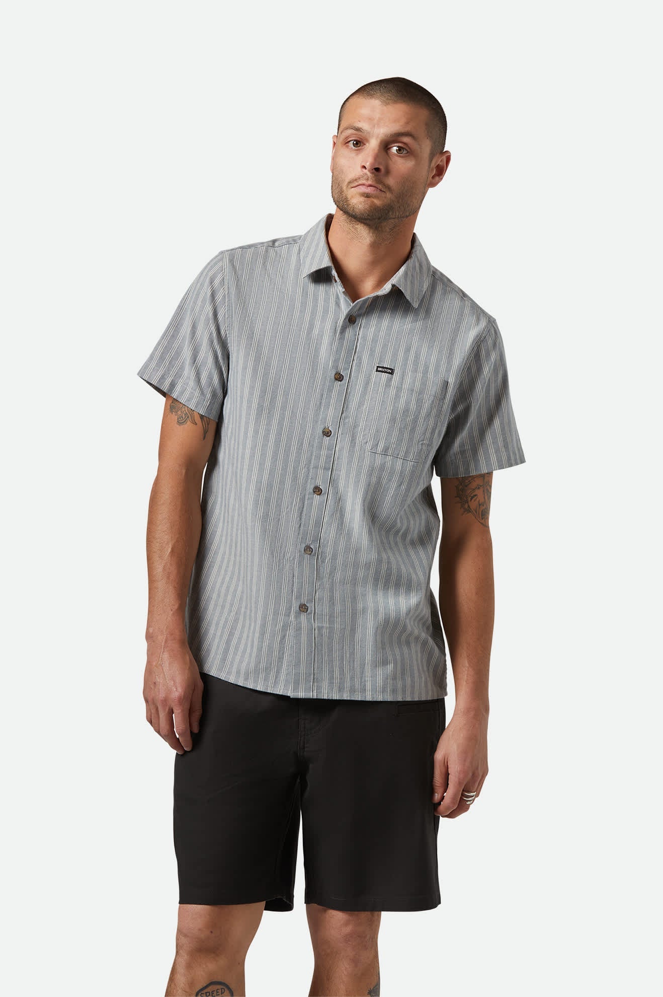 Model Photo of Brixton Men's Cru Oxford Strip Short Sleeve Shirt - Basalt Blue/Whitecap Stripe 