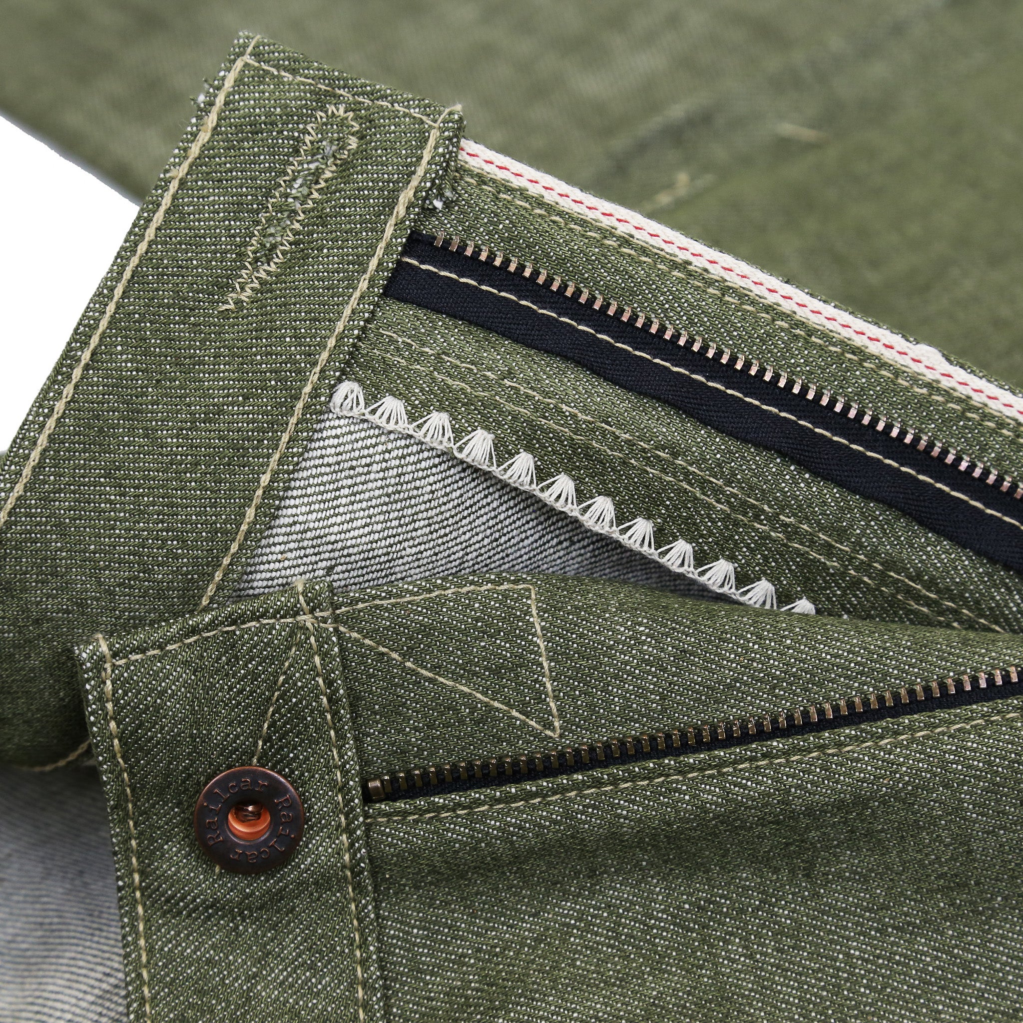 Zipper Detail of A pair of pistachio green, medium high waist, straight leg Railcar Drifter denim jeans