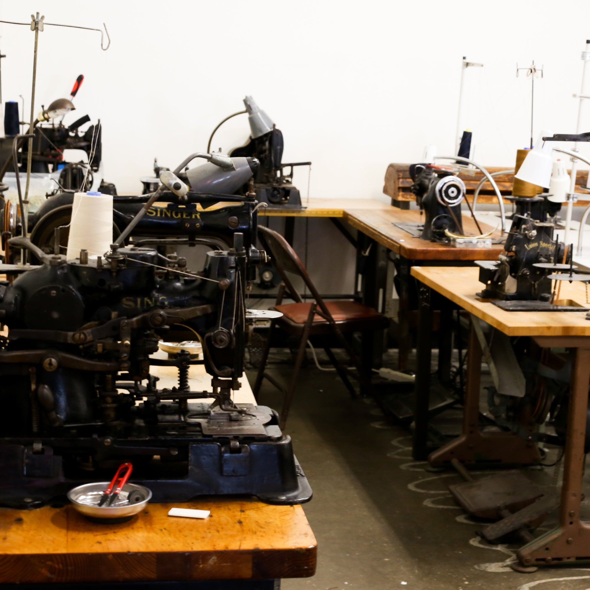 A workshop environment with multiple sewing machines and workstations