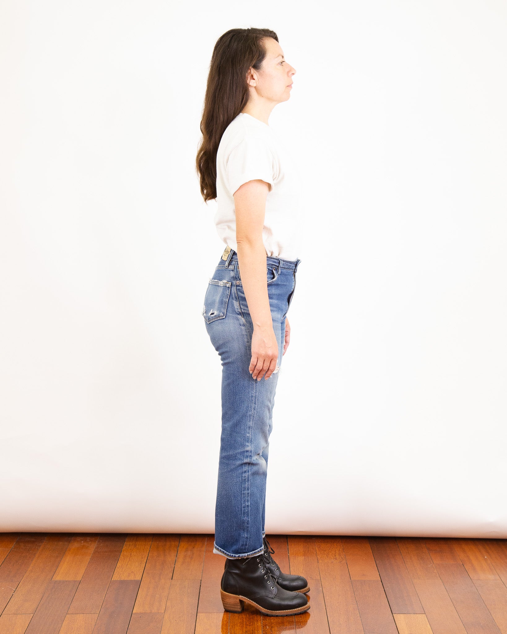 Model Photo of Side of Drifter X061 Pure Indigo Jeans with one year of wear and many consistent washes.