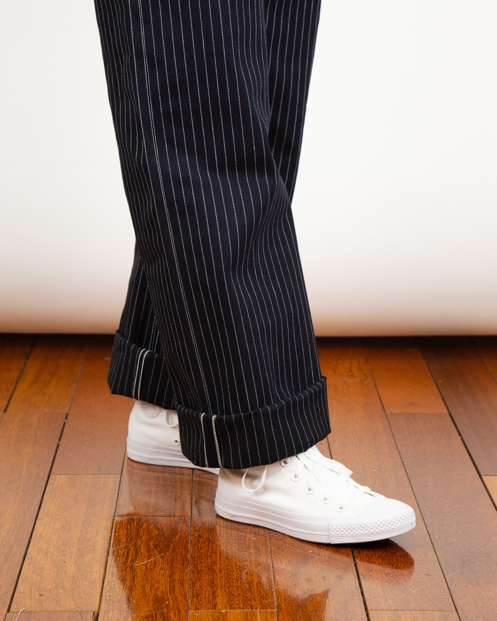 Model wearing Shadow Wabash Emily fit and white sneakers on a wooden floor.