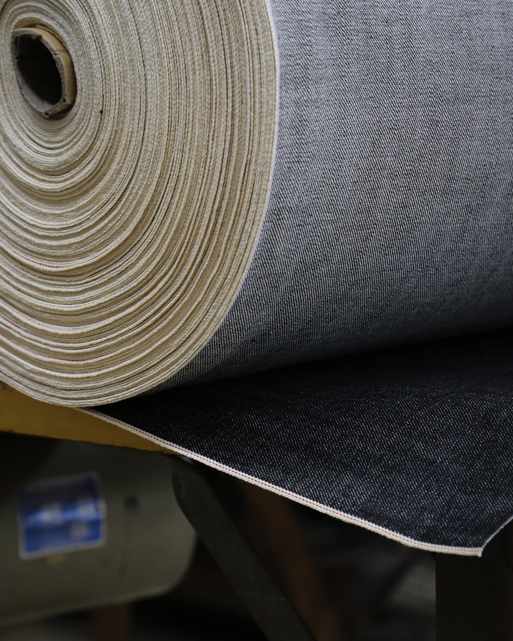 Roll of X129 denim fabric with a close-up view